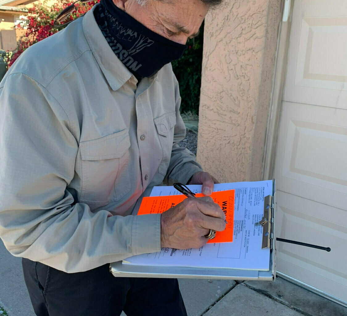 Then-Arrowhead Constable Michael Branham fills out a Writ of Restitution as part of the eviction process. Most eviction filings in the Valley come from north Phoenix, Tempe and the Glendale/Avondale areas.