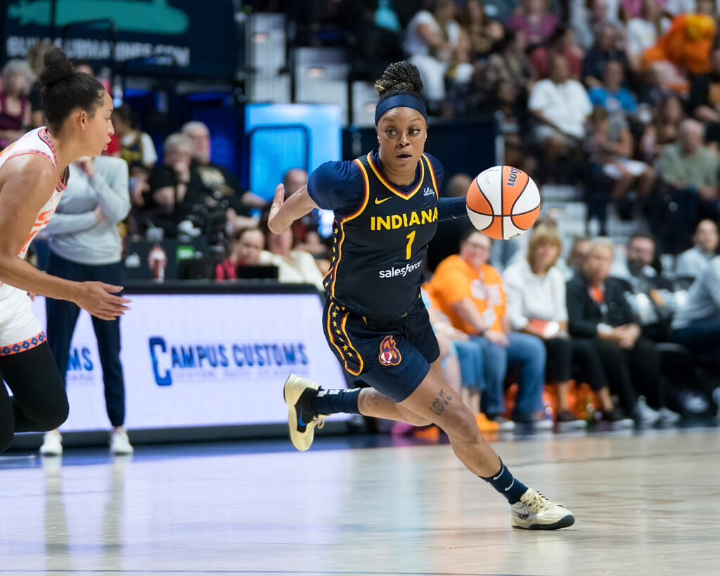 Odyssey Sims (1) dribbles around a Connecticut Sun defender during a game for the Indiana Fever.