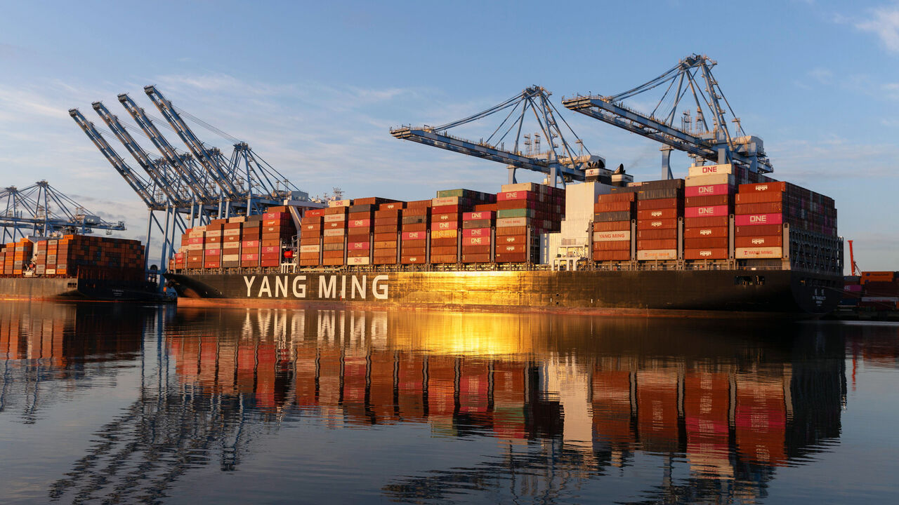 he sun rises over container ships docked at the Port of Tacoma's Husky Terminal in Tacoma, Washington