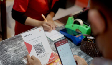 Residents make payments using QRIS (Quick Response Code Indonesia Standard) at a  merchant in Tulungagung, East Java, on August 21, 2025.