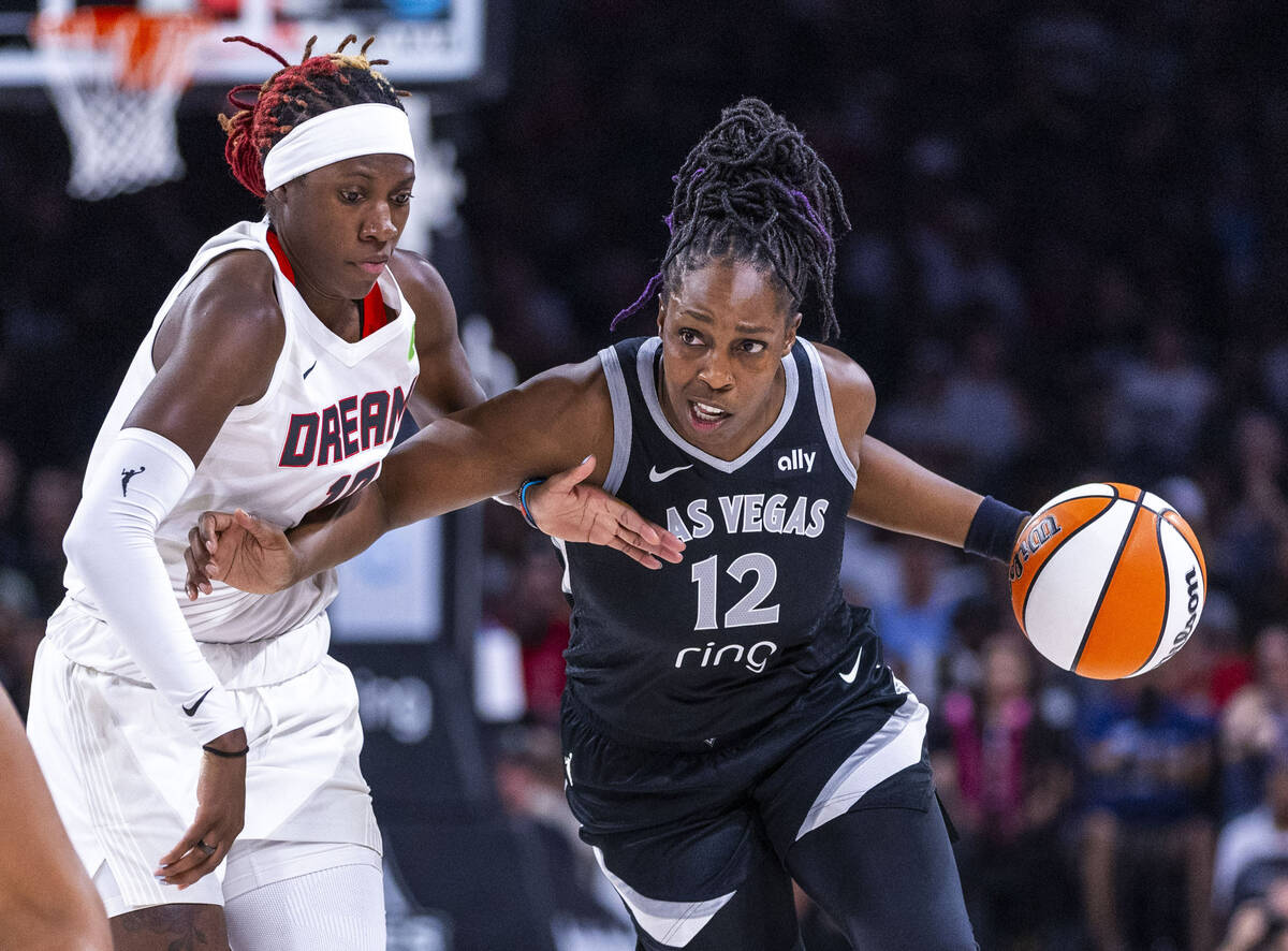 Aces guard Chelsea Gray (12) drives the lane as she battles with Atlanta Dream guard Rhyne Howa ...