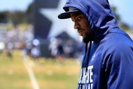 Dallas Cowboys defensive end Micah Parsons paces the sideline as he watched his teammates...