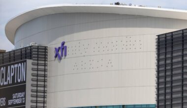 Workers putting up the Xfinity Mobile Arena signage at the Wells Fargo Center on Thursday.