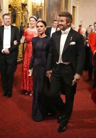 Getty Images Victoria and David Beckham at Buckingham Palace in December 2024