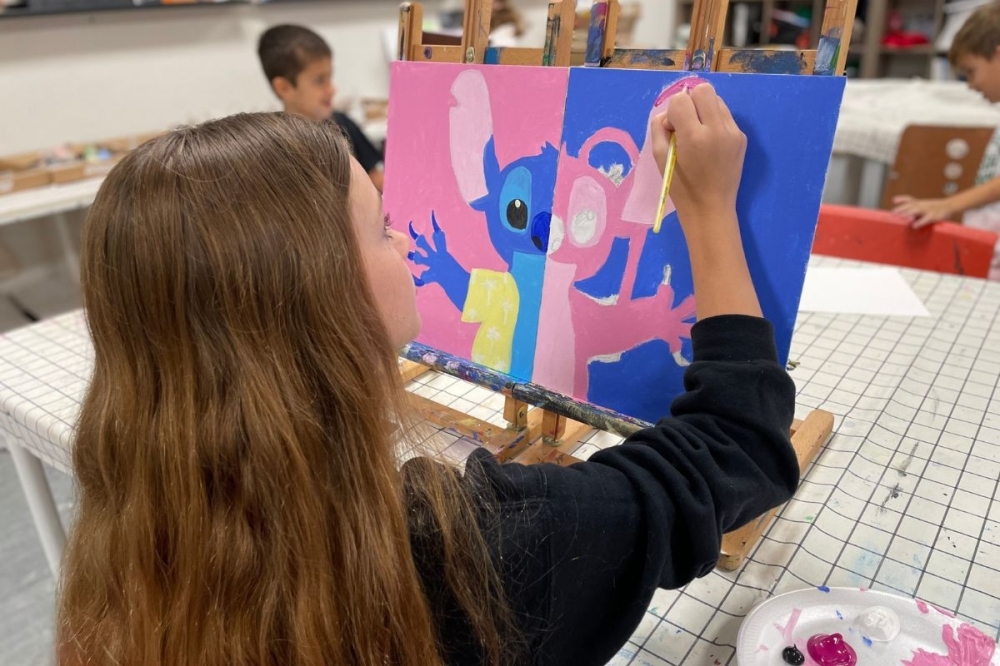 girl painting a canvas