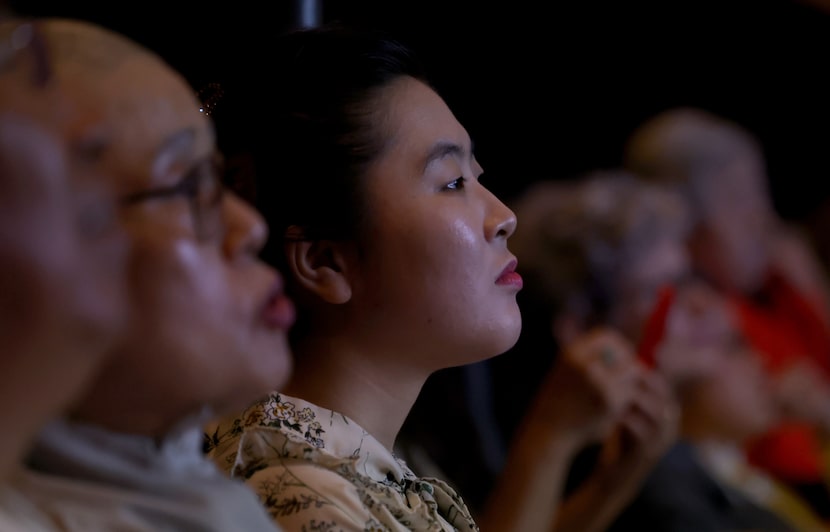 Ms. Lee Dasol listens intently to a speaker after her presentation of a piece of original...