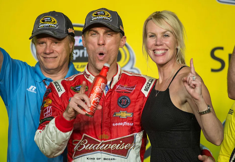 Sprint Cup Series driver Kevin Harvick (4) and wife DeLana Harvick celebrate winning the championship.