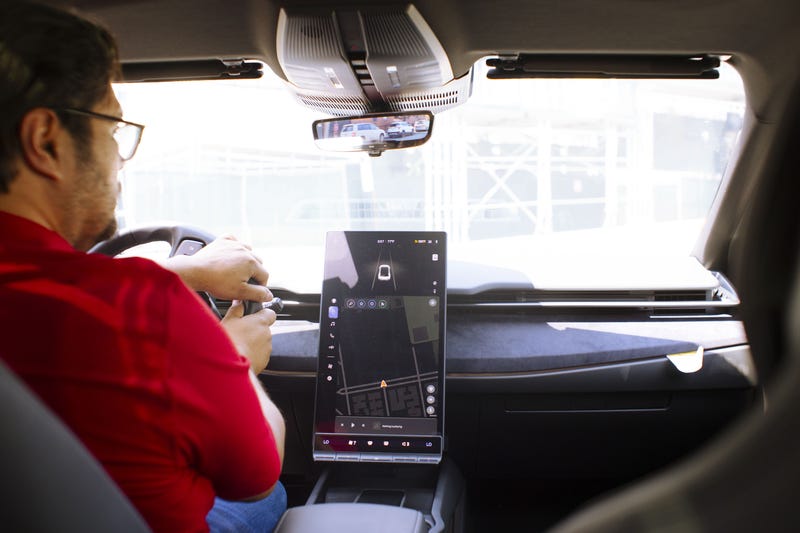 Ride-hailing driver Ruben Baldera behind the wheel of the new Ocean he rents.