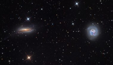 two swirls of colorful light on a starry background