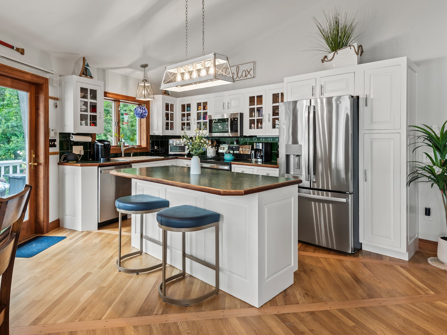 A new light fixture brightens up the kitchen island, which has seating for two.