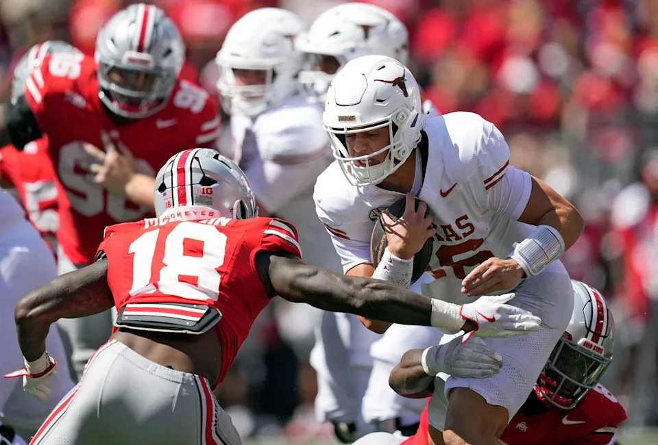 Aug 30, 2025; Columbus, Ohio, USA; Ohio State Buckeyes safety Jaylen McClain (18) tries to tackle Texas Longhorns quarterback Arch Manning (16) in the fourth quarter at Ohio Stadium. Mandatory Credit: Kyle Robertson - Imagn Images