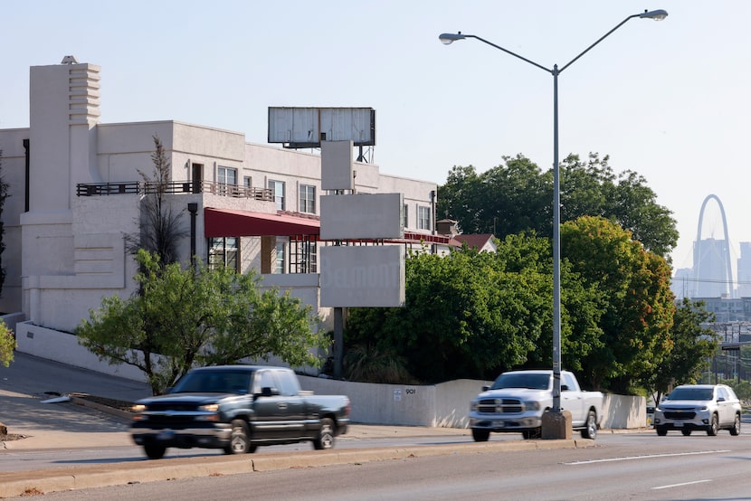 Cars drive past the former Belmont Hotel along Fort Worth Street, Monday, Aug. 5, 2024, in...