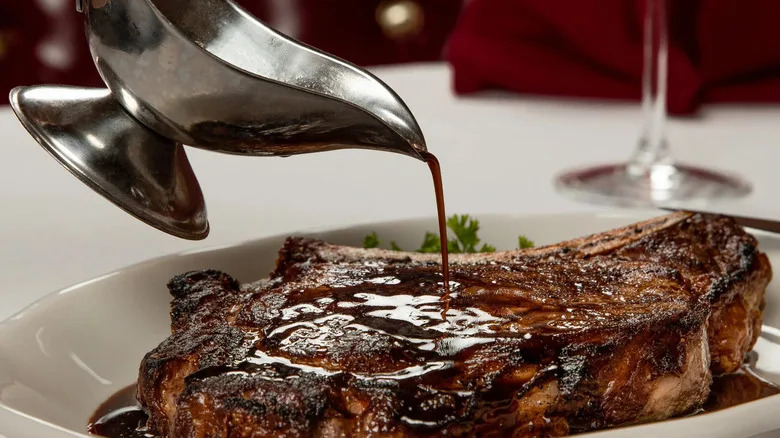 Sauce poured over a steak at the Golden Steer