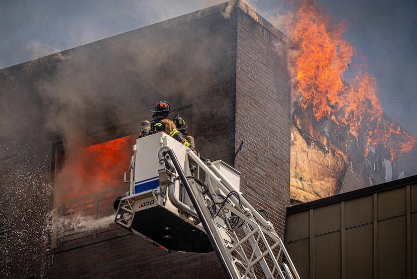 Firefighters attempt to extinguish a fire at the The Cooper, located at 1001 W. Rosedale...