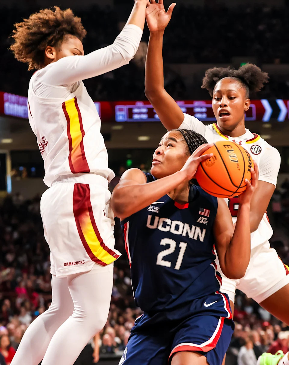 Feb 16, 2025; Columbia, South Carolina, USA; UConn Huskies forward Sarah Strong (21) looks to shoot over South Carolina Gamecocks guard Maddy McDaniel (1) and forward Joyce Edwards (8) in the second half at Colonial Life Arena. Mandatory Credit: Jeff Blake-Imagn Images