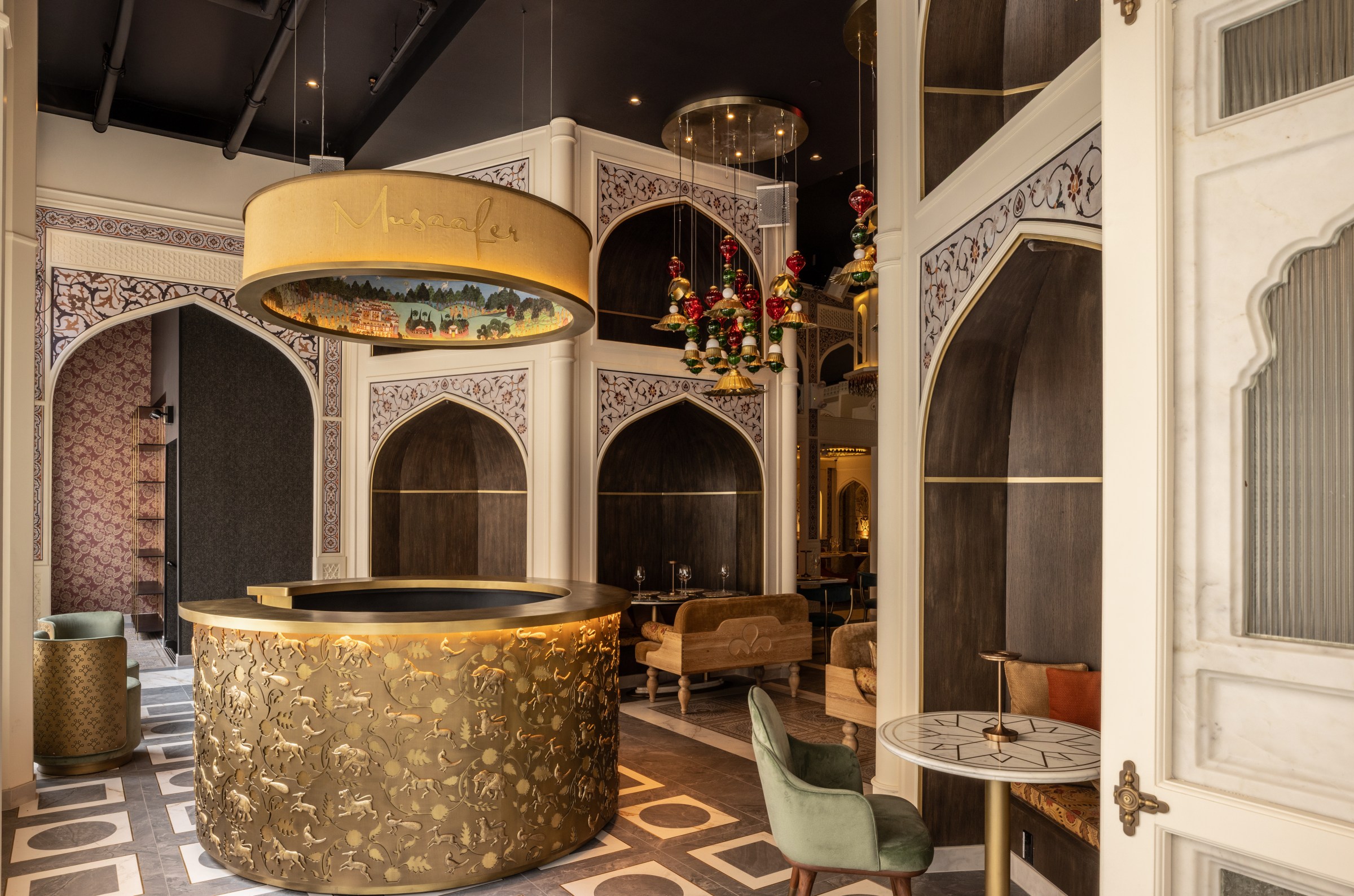 A restaurant room with a host stand and booths.