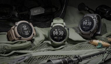 A photo of the green, grey, and brown COROS NOMAD watches sitting on a tent with camping equipment nearby.
