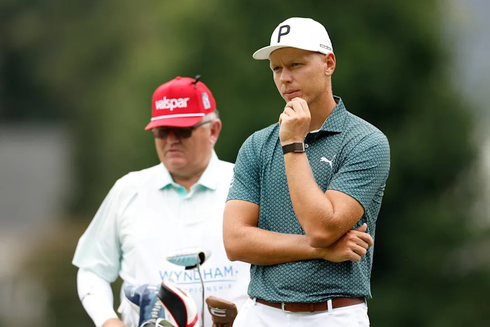 Matti Schmid and his caddie, Michael Waite, on the first hole during the final round of the 2025 Wyndham Championship at Sedgefield Country Club.