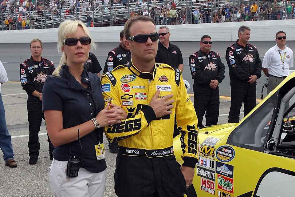 Kevin Harvick, driver of the #2 JEGS Chevrolet and his wife DeLana stand on the grid during the performance of the National Anthem prior to the NASCAR Camping World Truck Series F.W. Webb 175 at New Hampshire Motor Speedway on September 24, 2011.