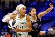 Dallas Wings guard DiJonai Carrington (21) attacks the paint against a defending Golden...