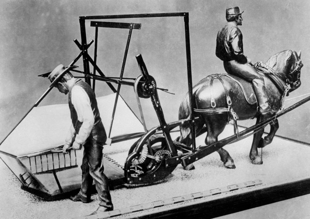 A scale size model of the first reaper is shown on Feb. 5, 1936. The mechanical reaper was invented by Cyrus McCormick and was based on designs by his father Robert McCormick. (AP)