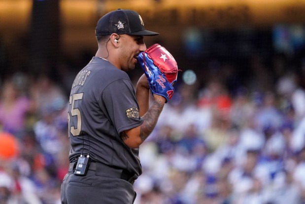 American League pitcher Nestor Cortes, of the New York Yankees, uses an earpiece and microphone to talk to his battery mate catcher Jose Trevino, also of the Yankees, betfore throwing a pitch to the National League during the sixth inning of the MLB All-Star baseball game, Tuesday, July 19, 2022, in Los Angeles. (AP Photo/Mark J. Terrill)
