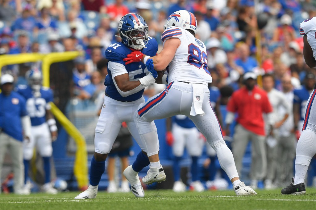 New York Giants linebacker Abdul Carter, left, is blocked by Buffalo Bills tight end Dawson Knox during the first half of an NFL preseason football game in Orchard Park, N.Y., Saturday, Aug. 9, 2025. 