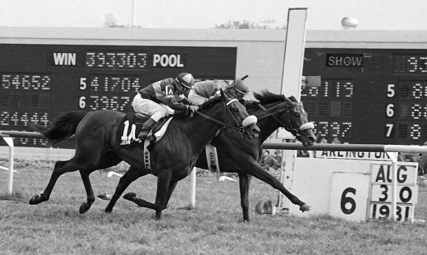John Henry (1A), with Bill Shoemaker up, wins the Arlington Million at Arlington Park in Arlington Heights, on Aug. 30, 1981. It was a photo finish with The Bart, ridden by Ed Delahoussaye (Jim Bourdier/AP)