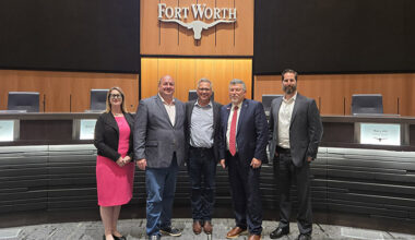 Motion carries: Kelly Baggett, Fort Worth Innovation Coordinator; District 10 Councilmember Alan Blaylock; John Lauer, Founder and CEO of Adom Industries; City Manager Jay Chapa; and Michael Hennig, Economic Development Manager, in chambers after Fort Worth City Council unanimously approved $15 million in incentives for Adom's $229 million cloud-connected electronics factory Tuesday night.