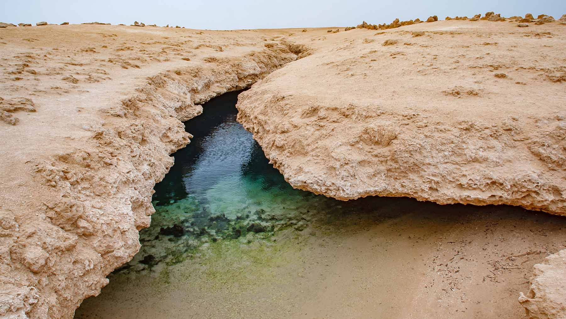 A Hidden Ocean May Be Growing Beneath Ethiopia There’s a quiet corner of Ethiopia where the land feels ancient and still — but it isn’t. Not really. Beneath the cracked, sun-warmed earth of the Afar region, something is shifting. Not in a way you can see, or even feel — but deep down, the planet is moving. And if you look closely enough, it seems to be preparing for something big. Not tomorrow. Not next year. But slowly, over lifetimes and beyond, the ground here may open wide. And one day, where now there is only dust and heat, there may be water — waves, tides, a whole new ocean. What makes this place so unusual is that three great pieces of the Earth’s crust — the Placa Nubia, the Placa Somalí, and the Placa Arábiga — all meet right here, and they’re quietly drifting apart. This kind of triple junction, known as the Tripla unión de Afar, is rare. It’s also exactly where the Red Sea, the Gulf of Aden, and the Ethiopian Rift begin to pull the continent in different directions. In the space between those shifts, the Earth is opening — gently, almost invisibly — through a process called rifting. And just beneath the surface, something is rising. Heat. Pressure. A steady pulse coming from the mantle terrestre. That deep breath from the planet is softening the crust, making way for change. A Pulse Beneath the Rock Geologist Emma Watts, working with the University of Southampton and Swansea University, has been part of a team studying this movement. Their research focused on 130 volcanic rock samples taken from the three rift zones that stretch across Afar. What they found feels almost alive: the mantle beneath the surface isn’t just heating up — it’s moving with a rhythm. Not violent, not chaotic. Just steady, like a heartbeat. With each slow push, molten material rises, thinning the crust, encouraging small cracks — fallas tectónicas — to widen. And there’s more. The chemical composition of that rising heat shifts depending on where it moves. Toward the Mar Rojo, it’s one thing. Toward the Golfo de Adén, another. The land isn’t just breaking; it’s telling a story, branch by branch, fault by fault. This is how oceans begin. The Continent That Remembers How to Move We forget that Africa, like all continents, is in motion. That the ground we walk on isn’t permanent. That it drifts. Changes. Re-forms. This is what’s known as deriva continental, and in the Afar region, it’s unfolding in real time. The Placa Nubia and Placa Somalí continue to drift apart. The Placa Arábiga pulls away too. As the Earth stretches, it thins. And if that stretching continues, seawater could one day flow into the valley that’s forming — turning this dry place into the floor of a nuevo océano. It’s not fast. It’s not loud. But it’s happening. A Story We’ll Never See the End Of There’s something humbling about this. About knowing that the Earth is shifting under us in ways we’ll never quite feel — but that future generations might one day sail across. Thanks to this research, we get a rare glimpse of what the planet looks like before an ocean is born. It doesn’t start with a splash. It starts with a silence. A widening. A pulse from deep below. So if one day a new sea does rise in Ethiopia, the story of its beginning will start here — in the stillness of the Afar region, where the Earth has quietly been preparing, all along.