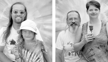 Two black-and-white portraits: On the left, an adult with long hair and glasses stands behind a child holding a rose. On the right, an older adult with a beard stands behind a woman holding a rose. Both backgrounds are tie-dye patterns.