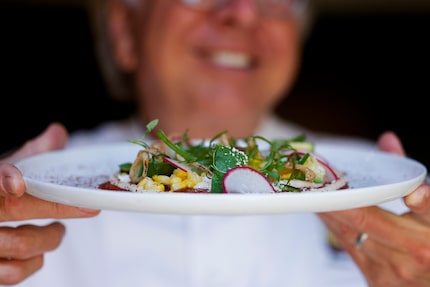 Dallas chef Dean Fearing holds a plate of Texas Wagyu Beef Carpaccio Elotes at Fearing's...