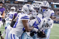 Dallas Cowboys cornerback Andrew Booth (25) celebrates with his teammates after scoring a...