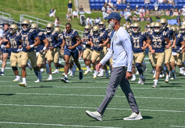 Navy coach Brian Newberry walks to the locker room after pregame warmups. The Navy Midshipmen play their NCAA football season opener at home against the visiting VMI Keydets at Navy-Marine Corps Memorial Stadium in Annapolis. (Paul W. Gillespie/Staff)