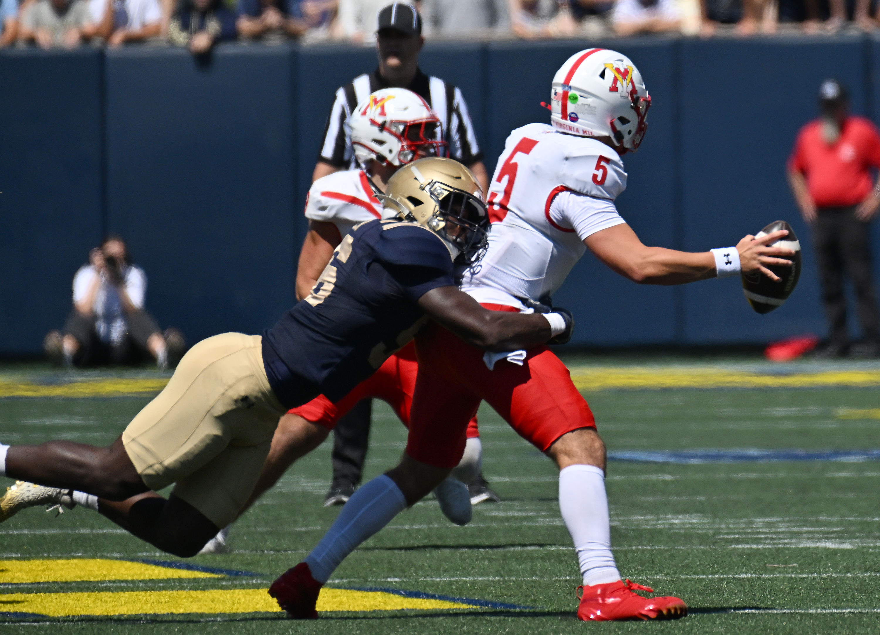 Navy linebacker MarcAnthony Parker sacks VMI quarterback Collin Shannon and Navy takes over on downs in the second quarter. The Navy Midshipmen play their NCAA football season opener at home against the visiting VMI Keydets at Navy-Marine Corps Memorial Stadium in Annapolis. (Paul W. Gillespie/Staff)