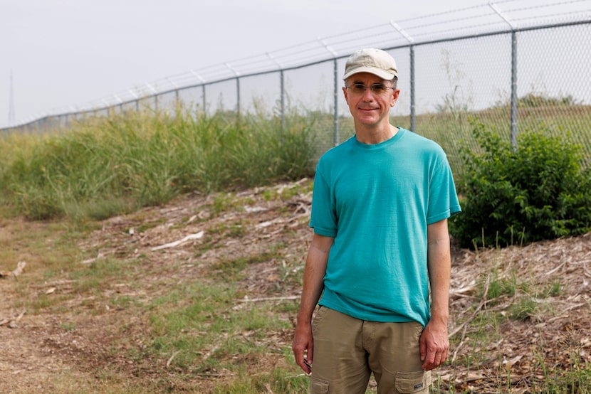 Birdwatcher Colby Ayers stands near a newly erected barbed wire fence blocking entry to the...