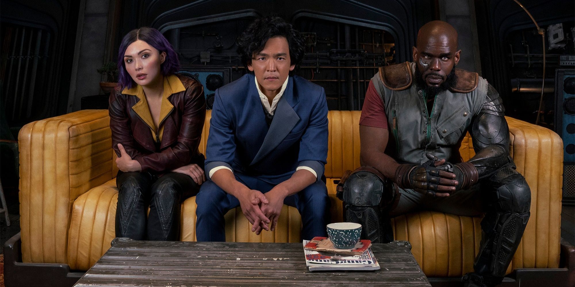 Faye Valentine, Spike Spiegel, and Jet Black on a couch in Netflix's live action Cowbow Bebop