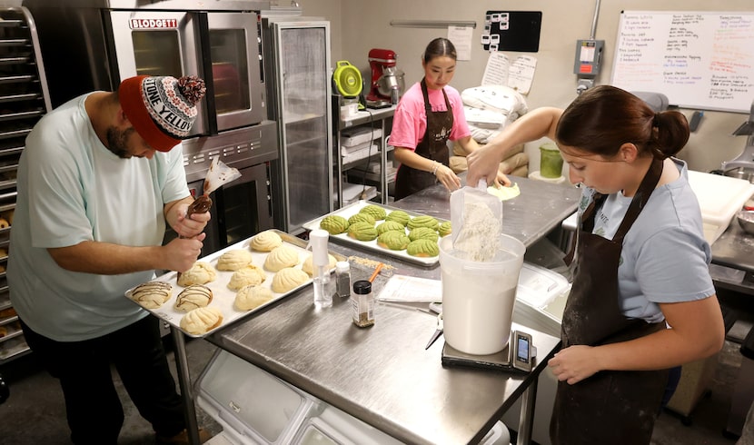 The kitchen at Pan Pan bakery was hopping with activity as head baker Jaylin Shepherd, left,...