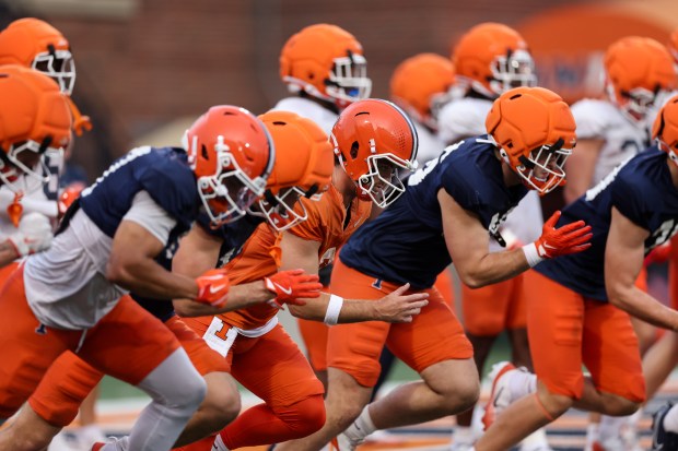 Illinois quarterback Luke Altmyer (9) runs with other players during practice at Memorial Stadium on Aug. 7, 2025, in Champaign. (Armando L. Sanchez/Chicago Tribune)