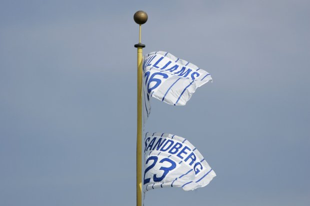 Flags representing retired jerseys for Hall of Fame Chicago Cubs players Billy Williams (No. 26) and Ryne Sandberg (No. 23) wave atop a foul pole at Wrigley Field on Aug. 28, 2005. (José M. Osorio/Chicago Tribune)