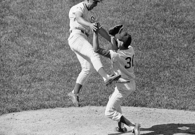Chicago Cubs third baseman Ron Santo, left, leaps in the air after rushing to the mound to congratulate Ken Holtzman after he no-hit the Atlanta Braves in Chicago on Aug. 19, 1969. Holtzman, who walked three, said he relied mostly on fast balls enroute to his first career no-hitter. Santo hit a three-run homer in the first, and the Cubs won, 3-0. (James Palmer/AP)