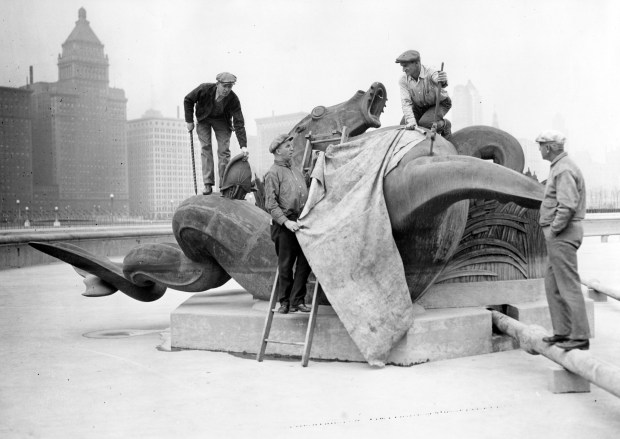 Workers mount one of four bronze statues during the construction of Buckingham Fountain in 1926. The fountain was dedicated at a grand ceremony in August 1927, an event of enormous civic pride. (Chicago Herald and Examiner photo)