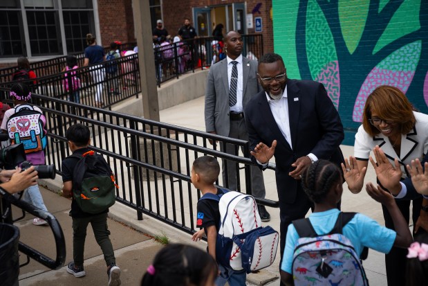 Mayor Brandon Johnson and interim CPS CEO Dr. Macquline King greet students at the Courtenay Language Arts Center in the Uptown neighborhood on the first day of school on Aug. 18, 2025. (E. Jason Wambsgans/Chicago Tribune)