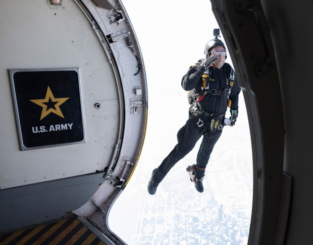 Staff Sgt. Nickolas Orozco, of the U.S. Army Golden Knights parachute team, leaps out of an airplane during a practice jump for the Chicago Air and Water Show on Aug. 18, 2023. (Trent Sprague/Chicago Tribune)