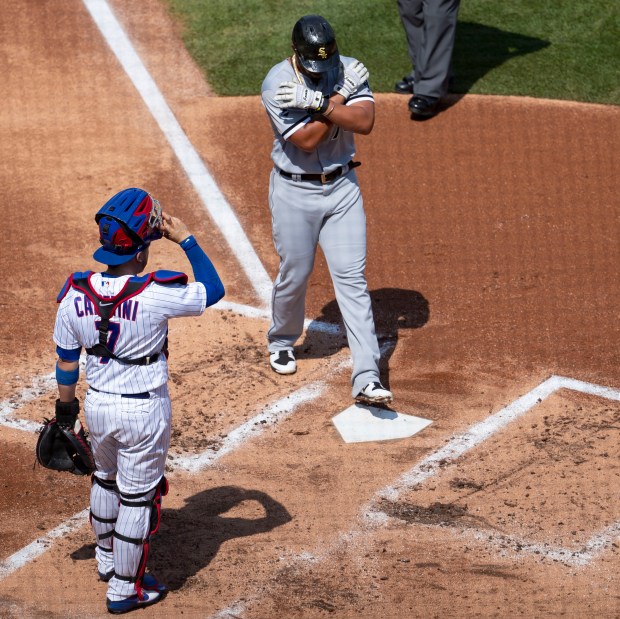 Chicago White Sox first baseman Jose Abreu crosses the plate after hitting a home run in front of Chicago Cubs catcher Victor Caratini in the second inning of a game on Aug. 23, 2020, at Wrigley Field. (Brian Cassella/Chicago Tribune)