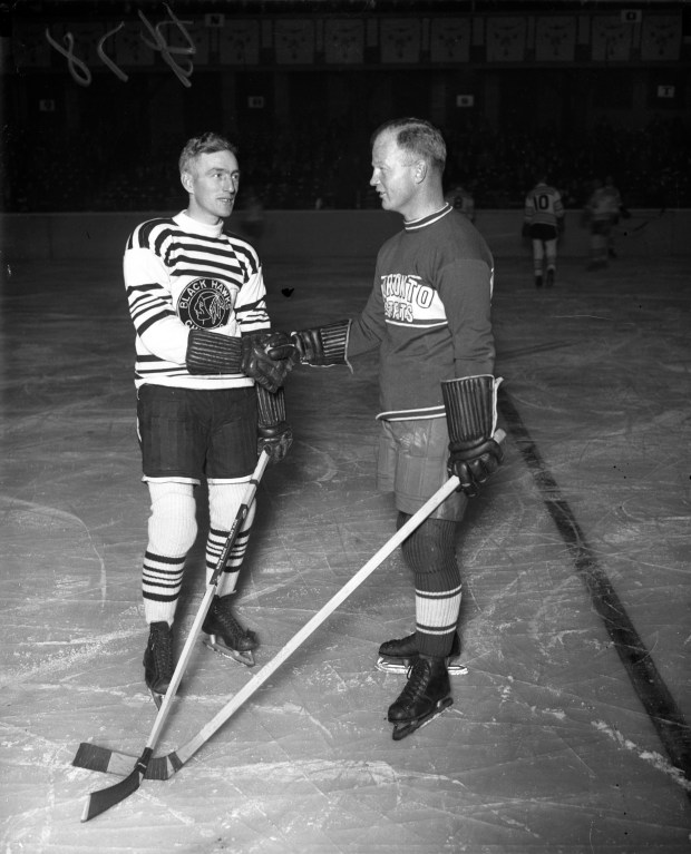 Dick Irvin, captain of the Chicago Blackhawks, left, and Bert Corbeau, right, captain of the Toronto St. Pats shake hands just before the start of the Hawks' first game ever on Nov. 17, 1926, at the Chicago Coliseum. The Tribune reported, "Chicago's Blackhawks started their national professional hockey league season with a rush last night when they defeated the St. Patrick's sextet from Toronto, Ont. 4 to 1, on the new Coliseum rink. The sport was accorded a great reception. More than 7,000 pushed their way into the building, and there were cheers from the time the game started until the final whistle. There was action in every period and the fans, many of them watching their first hockey match, greeted the efforts of the players with generous applause." (Chicago Herald and Examiner)