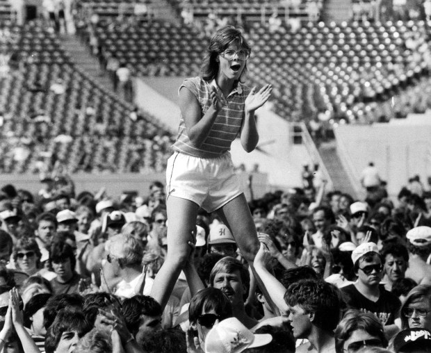 Hoisted onto shoulders, a fan cheers for the rock group Chicago during their appearance on Aug. 14, 1983, at ChicagoFest at Soldier Field. (Chuck Berman/Chicago Tribune)