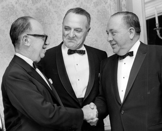 Leo Burnett, left, is named the 1966 marketing man of the year and receives congratulations from Rome G. Arnold, center, president of the Chicago chapter of the American Marketing Association, and from Mayor Richard J. Daley, right, on Feb. 11, 1966. (Chicago Tribune historical archive)