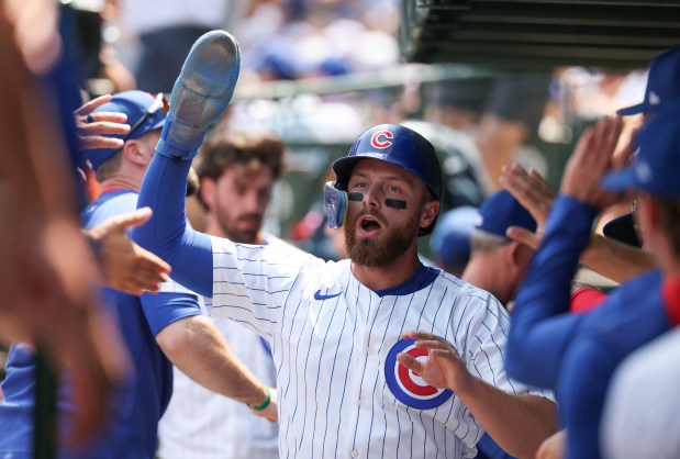 Chicago Cubs first base Michael Busch celebrates in the dugout after scoring against the Baltimore Orioles in the first inning Sunday, Aug. 3, 2025, at Wrigley Field. (Brian Cassella/Chicago Tribune)