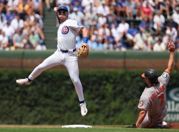 Chicago Cubs second base Nico Hoerner forces out Baltimore Orioles second base Jackson Holliday but can't complete the double play in the third inning Sunday, Aug. 3, 2025, at Wrigley Field. (Brian Cassella/Chicago Tribune)